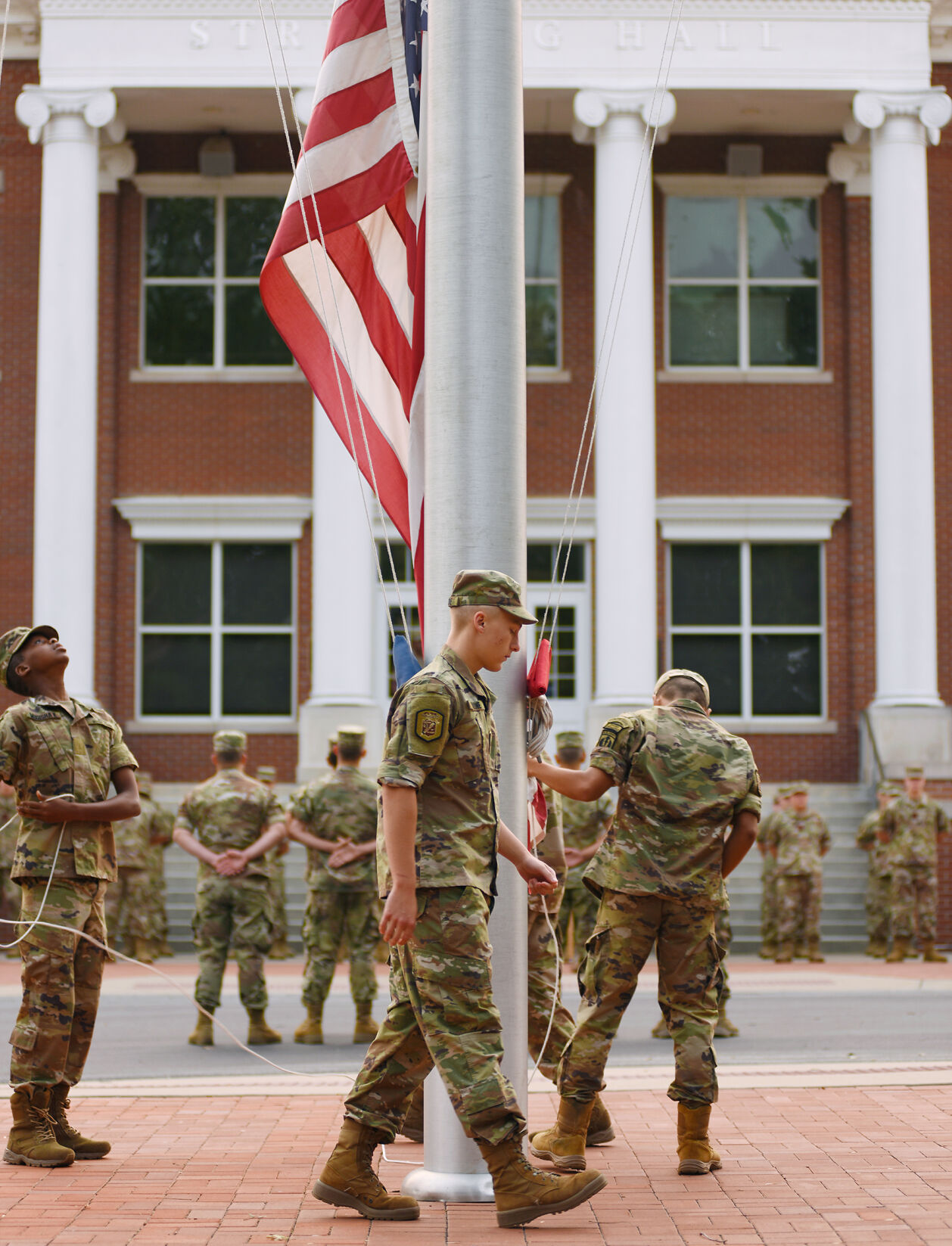 Cadet Zachary Malone raises the flag at the start of the 9/11 ceremony